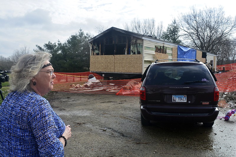 FILE - In this Sunday, April 7, 2019, file photo, Marie Chockley, a resident of the Timberline Trailer Court, north of Goodfield, Ill., surveys the damage that was caused by a Saturday night fire that killed five residents in a mobile home. A prosecutor says a central Illinois 9-year-old is expected to be charged Tuesday with five counts of first-degree murder in connection with the deadly mobile home fire. (Kevin Barlow/The Pantagraph via AP, File)