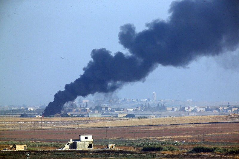 In this photo taken from the Turkish side of the border between Turkey and Syria, in Akcakale, Sanliurfa province, southeastern Turkey, smoke billows from a fire inside Syria during bombardment by Turkish forces Wednesday, Oct. 9, 2019. Turkey launched a military operation Wednesday against Kurdish fighters in northeastern Syria after U.S. forces pulled back from the area, with a series of airstrikes hitting a town on Syria's northern border.