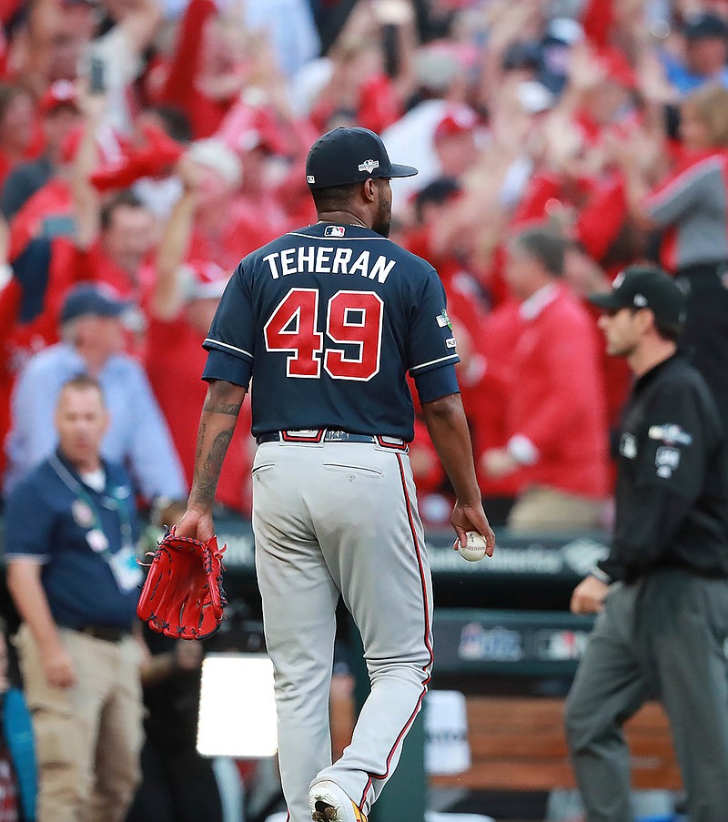 Atlanta Braves pitcher Julio Teheran walks off the field after giving up a winning sacrifice fly to St. Louis Cardinals' Yadier Molina to score Kolten Wong during the 10th inning of Game 4 of a baseball National League Division Series, Monday, Oct. 7, 2019, in St. Louis. (Curtis Compton/Atlanta Journal-Constitution via AP)