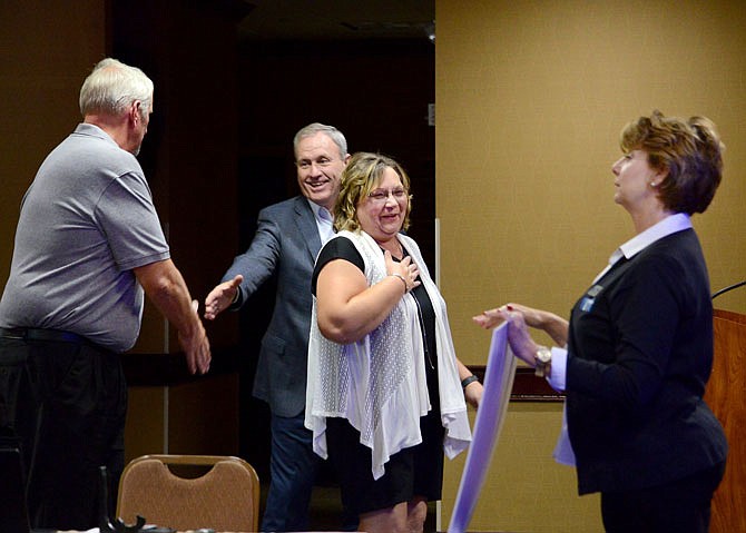 2019 FILE: Owners Jeff and Rita Huff are shocked as they make their way to the front of the room to accept a $5,000 check during the Pitch It & Win It competition at Capitol Plaza Hotel. The Huffs competed with four other business as they proposed how they would like to expand their company, RJ's Real Italian Ice, with the winnings. 