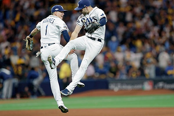 Rays shortstop Willy Adames (1) and center fielder Kevin Kiermaier celebrate after Tuesday night's 4-1 win against the Astros in Game 4 of the American League Division Series in St. Petersburg, Fla.
