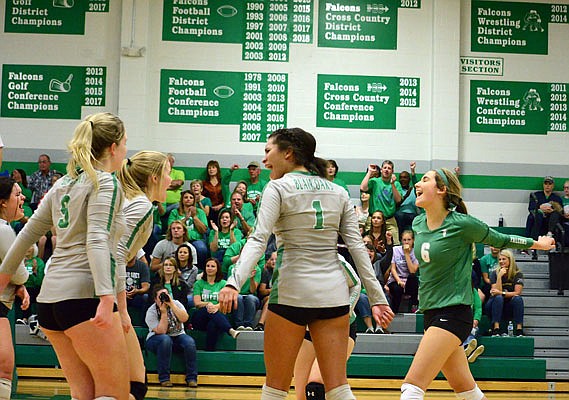 The Blair Oaks Lady Falcons celebrate Tuesday night after defeating the Helias Lady Crusaders in Wardsville.