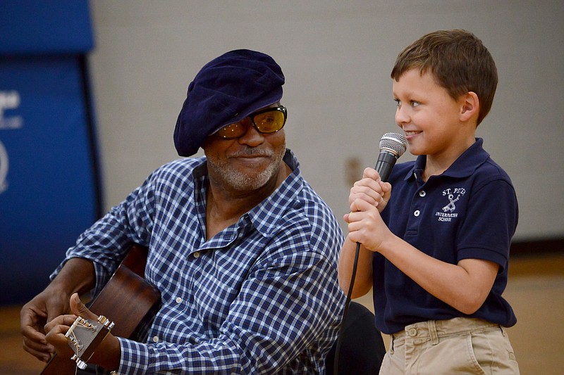 <p style="text-align:right;">News Tribune file photo</p><p>Second-grade student Brenden Ralston, 7, right, sings the blues with musician Fruteland Jackson in October 2018 during a Blues in the Schools program at St. Peter Interparish School. The MO Blues Association will host its annual Blue Sunday event, which raises money for the Blues in the Schools program, this weekend.</p>