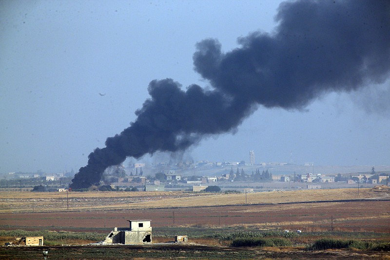 In this photo taken from the Turkish side of the border between Turkey and Syria, in Akcakale, Sanliurfa province, southeastern Turkey, smoke billows from a fire inside Syria during bombardment by Turkish forces Wednesday, Oct. 9, 2019. Turkey launched a military operation Wednesday against Kurdish fighters in northeastern Syria after U.S. forces pulled back from the area, with a series of airstrikes hitting a town on Syria's northern border.(AP Photo/Lefteris Pitarakis)