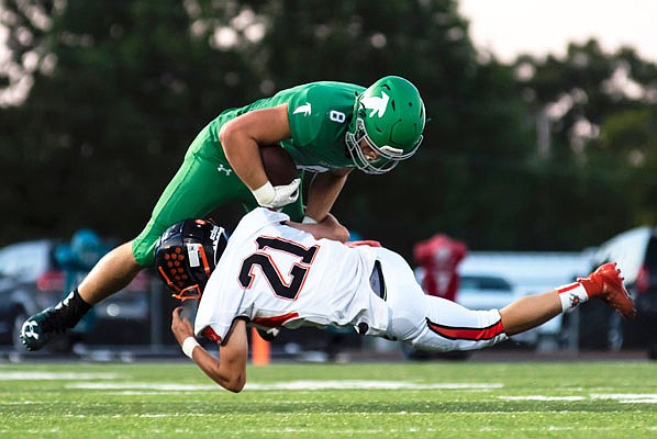 Blair Oaks wide receiver Reid Dudenhoeffer tries to escape a tackle by Oak Grove linebacker Richard Lopez during a game earlier this season at the Falcon Athletic Complex in Wardsville.