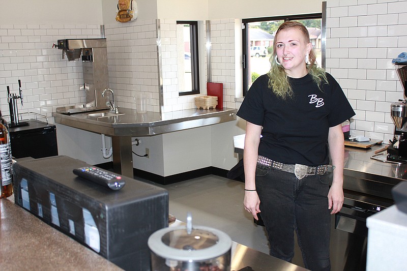 Chuck Taramona, manager of Brewster's on the Boulevard, takes position behind the counter, ready to brew up something hot (or cold) and tasty for coffee fans. A veteran barista, she was instrumental in helping set up the local coffee house, which will hold its grand opening at 5 p.m. Tuesday.