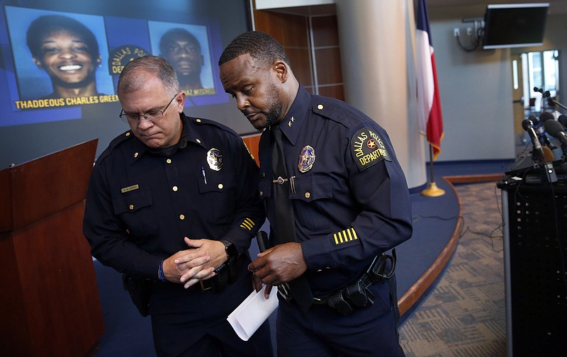 Dallas Assistant Chief of Police Avery Moore, right, walks away from the podium after addressing the media about a drug deal gone bad, resulting in the death of Joshua Brown at Dallas Police Headquarters in Dallas, Tuesday, Oct. 8, 2019. (Tom Fox/The Dallas Morning News via AP)