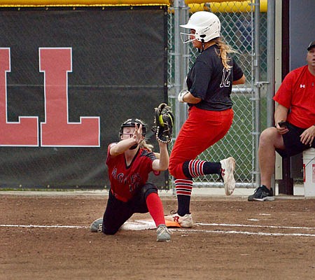 Megan Green of Jefferson City runs across first base as Addison Lange of Southern Boone catches a throw during Wednesday's game at Vogel Field.