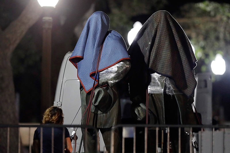 In this Aug. 21, 2017 file photo, Confederate statutes removed from the University of Texas are secured to a trailer, in Austin, Texas. Judges for the 5th U.S. Circuit Court of Appeals heard oral arguments Tuesday Oct. 8, 2019, in the latest effort to counter the University of Texas' removal of several Confederate statues. In 2017, after violent white supremacist demonstrations in Charlottesville, Va., UT President Gregory L. Fenves authorized the removal of statues of Confederate figures — Robert E. Lee, Albert Sidney Johnston and John Reagan — along with Gov. James Stephen Hogg from the UT South Mall. (AP Photo/Eric Gay, File)