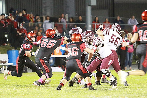 The School of the Osage Indians battle the Southern Boone Eagles at the line of scrimmage during last Friday night's Tri-County Conference game in Ashland.