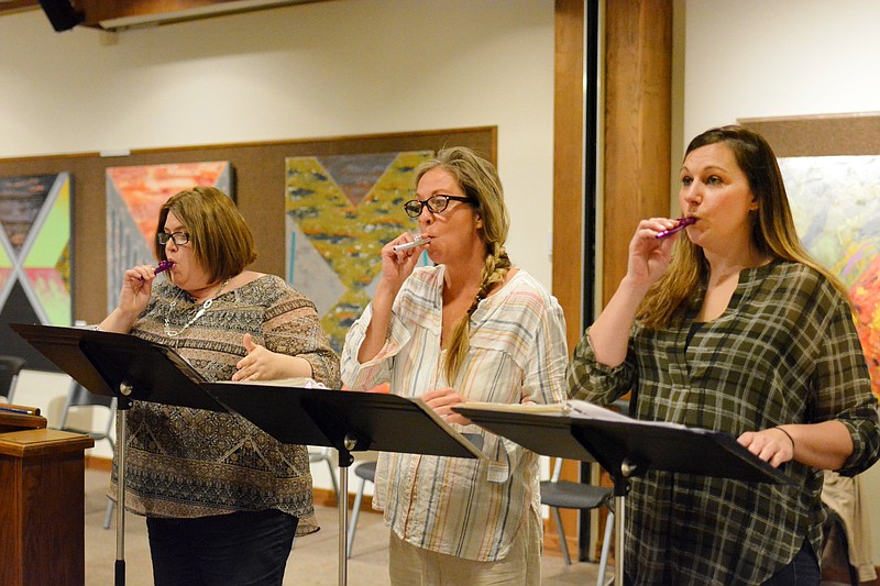 From left, Tracy Wegman, Megan Sappington and Tammy Acosta sound their kazoos Wednesday as they rehearse for the Reader's Theatre at the Missouri River Regional Library. The library will host the Reader's Theatre on Friday and Saturday night.