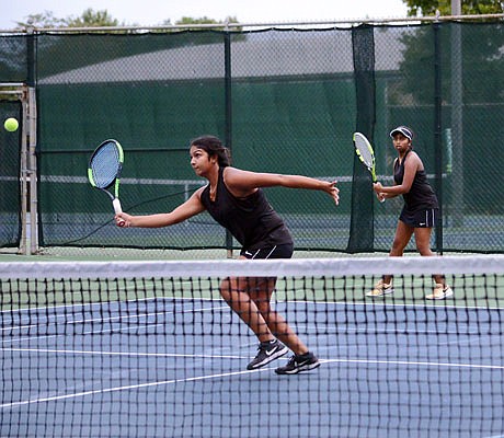 Sandhiya Baskar of Jefferson City makes a return as her doubles teammate Sudhi Kumar watches Wednesday in the Class 2 District 8 Tournament championship dual against Helias at Washington Park.