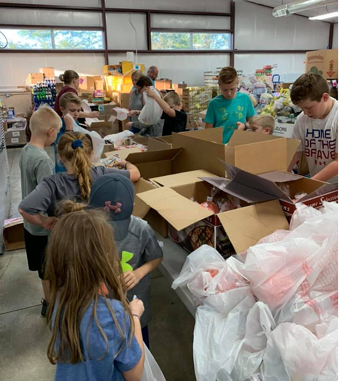 <p>Submitted photo</p><p>Members of Shamrock 4-H help to pack Buddy Packs at Cargill Cares. This was one of the many acts of service the group has performed during the past year.</p>