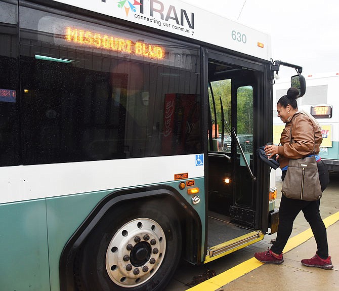 Keyonna Warren boards a JeffTran bus Thursday at the East Miller Street transfer station. Warren and her children are regular users of the city-offered transportation service, which will offer a free ride day Monday.