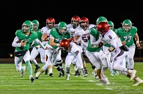 Blair Oaks quarterback Dylan Hair (left) breaks through the line and finds open running room in the first quarter Friday of the Falcons' Homecoming game against Southern Boone at Wardsville.