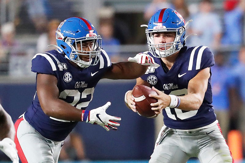 Mississippi quarterback John Rhys Plumlee hands off to running back Scottie Phillips during the first half of Saturday's game against Vanderbilt in Oxford, Miss. Plumlee and Phillips average a combined 184 yards rushing per game.