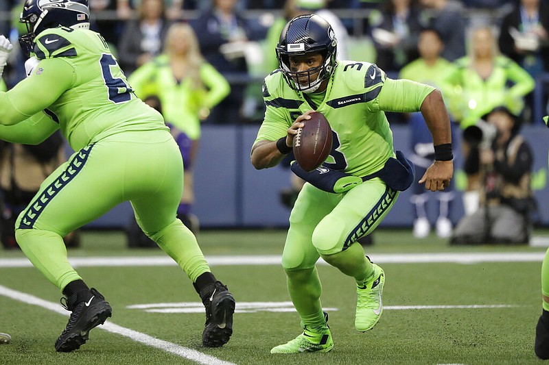 Seattle Seahawks quarterback Russell Wilson (3) scrambles against the Los Angeles Rams during the first half of an NFL football game, Thursday, Oct. 3, 2019, in Seattle. (AP Photo/Elaine Thompson)