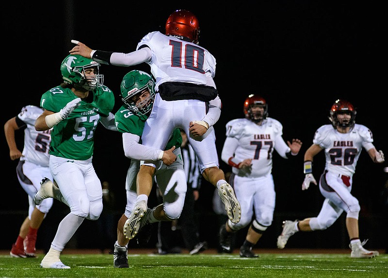 Blair Oaks defensive lineman Rylee Niekamp lays a hit on Southern Boone quarterback Tyson Smith just as he fires a pass downfield during Friday night's Homecoming game at the Falcon Athletic Complex in Wardsville.