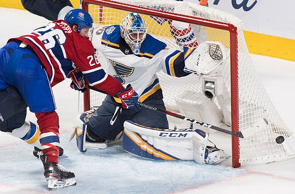 Jeff Petry of the Canadiens moves in on Blues goaltender Jordan Binnington during the second period of Saturday's game in Montreal.