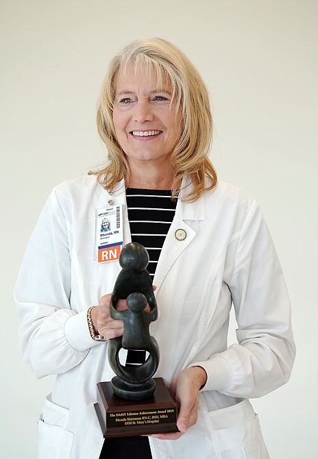 Rhonda Shimmens holds the statue she was recently awarded for the DAISY Lifetime Achievement Award at St. Mary's Hospital. Shimmens has devoted her 43-year medical career to St. Mary's Hospital.