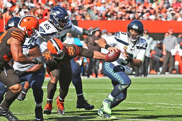 Seahawks quarterback Russell Wilson scrambles against the Browns during the second half of Sunday afternoon's game in Cleveland.