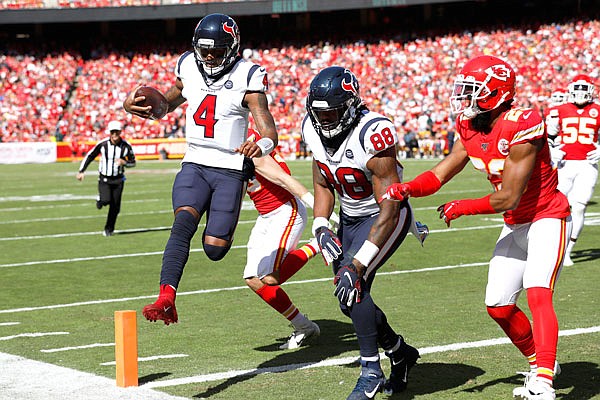 Texans quarterback Deshaun Watson scores a touchdown next to tight end Jordan Akins (88) during the first half of Sunday afternoon's game against the Chiefs at Arrowhead Stadium in Kansas City.