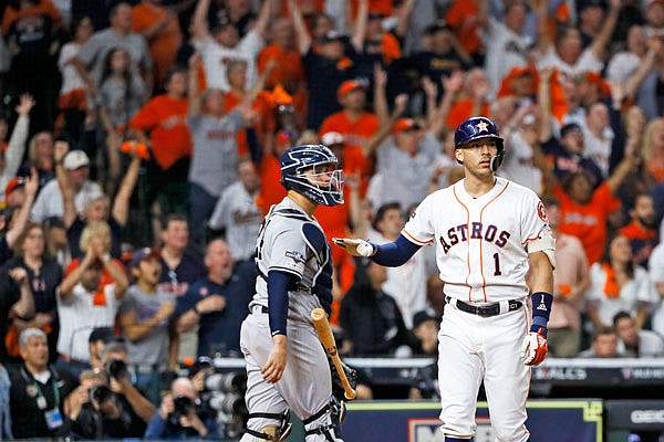 Carlos Correa of the Astros watches his walk-off home run against the Yankees during the 11th inning Sunday in Game 2 of the American League Championship Series in Houston.