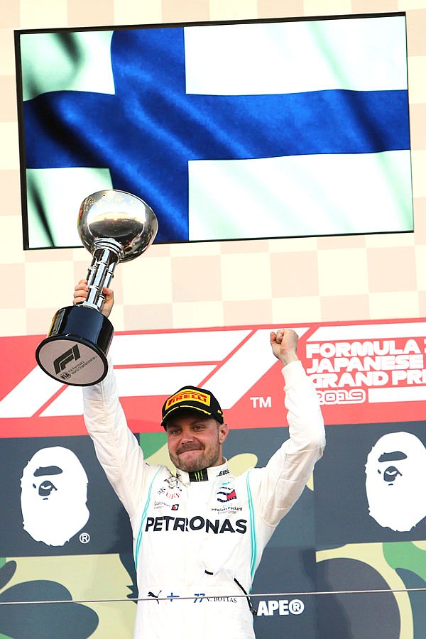 Mercedes driver Valtteri Bottas raises his trophy on the podium Sunday after winning the Formula One Japanese Grand Prix at Suzuka Circuit in Suzuka, Japan.