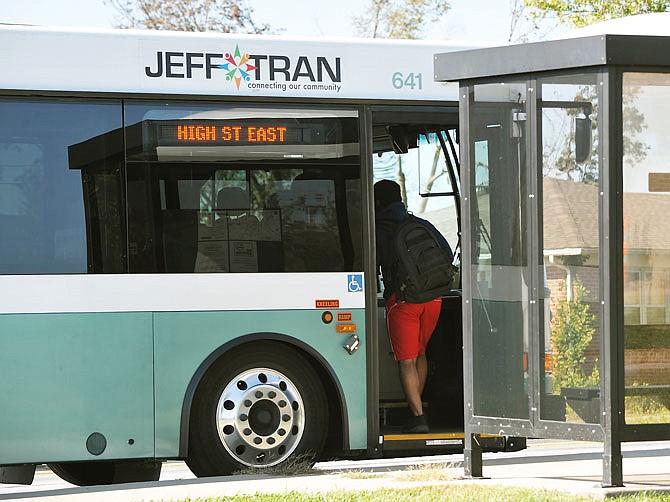 A rider boards the JeffTran High Street East bus from the stop in front of 409 Ellis Blvd. on Monday morning, Oct. 14, 2019.