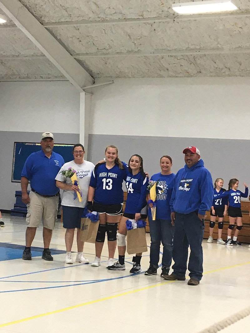 Submitted photo8th grade High Point volleyball players Zoey Percival and Jillian Schmidt, pictured here with their parents, were recognized Oct. 8. The team played against the Capital City Comets and then against their families in a parent game.