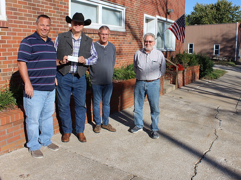 <p>Democrat photo/Austin Hornbostel</p><p>California Area Chamber of Commerce President Blake Howard presents Moniteau County Toys for Tots Program Coordinator Dan Mesey with a check for $1,000 from the Chamber. Chamber members Brad Baer and Norris Gerhart joined Howard in presenting the donation, which Mesey said has been a consistent show of support from the Chamber since Toys for Tots came to Moniteau County in 2017.</p>