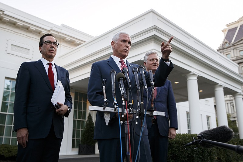 Vice President Mike Pence, with Treasury Secretary Steven Mnuchin, left, and national security adviser Robert O'Brien, speaks to reporters outside the West Wing of the White House, Monday, Oct. 14, 2019, in Washington. The U.S. is calling for an immediate ceasefire in Turkey's strikes against Kurds in Syria, and is sending Pence to lead mediation effort (AP Photo/Jacquelyn Martin)