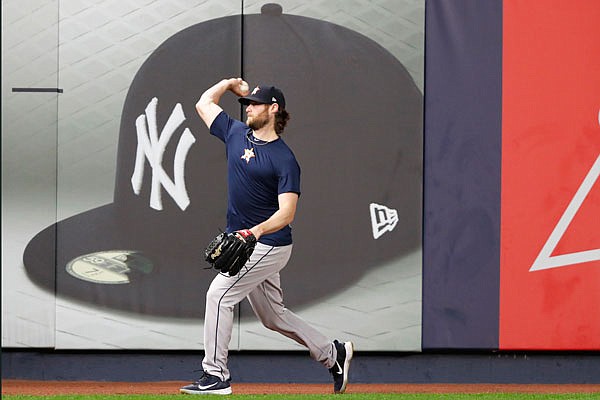 Astros Game 3 starting pitcher Gerrit Cole throws on the field Monday after the team arrived to prepare for the American League Championship Series, which continues today at Yankee Stadium in New York.