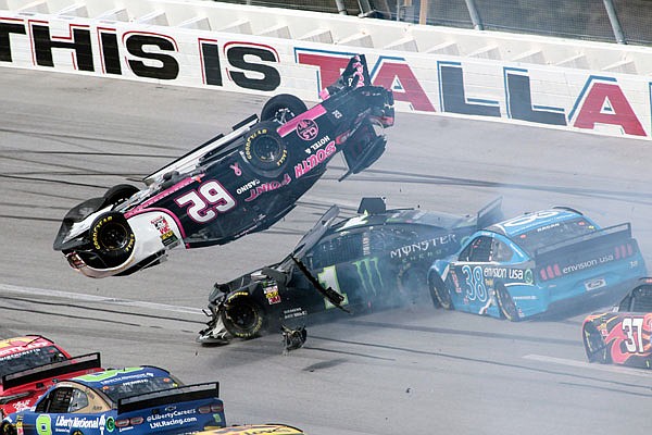 Brendan Gaughan (62) flips in Turn 3 as Kurt Busch (1) and David Ragan (38) pass underneath during Monday afternoon's NASCAR Cup Series race at Talladega Superspeedway in Talladega, Ala.