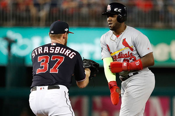 Stephen Strasburg of the Nationals tags out Marcell Ozuna of the Cardinals after being caught in a rundown during the second inning of Monday night's Game 3 of the National League Championship Series in Washington.