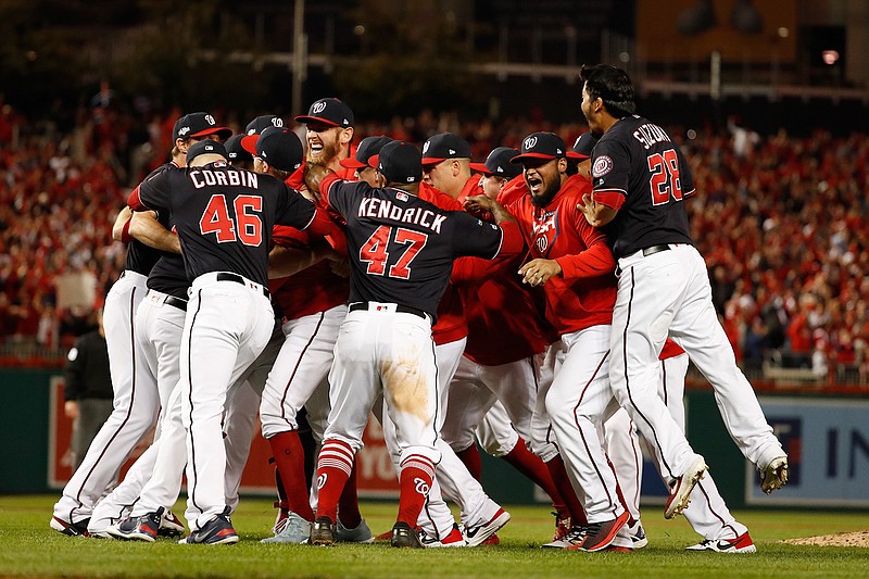 The Washington Nationals celebrate after Game 4 of the baseball National League Championship Series Tuesday, Oct. 15, 2019, in Washington. The Nationals won 7-4 to win the series 4-0. (AP Photo/Jeff Roberson)