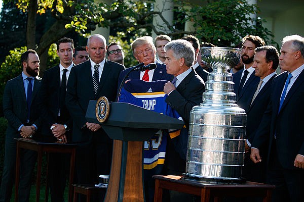 President Donald Trump is presented a team jersey Tuesday by Blues owner Tom Stillman during an event to honor the 2019 Stanley Cup champion Blues in the Rose Garden of the White House in Washington.