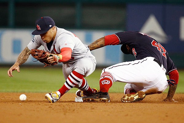 Howie Kendrick of the Nationals is safe at second as Kolten Wong of the Cardinals can't handle the ball during the first inning of Tuesday night's Game 4 of the National League Championship Series in Washington.