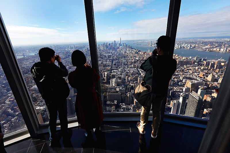 People look at the south view in the 102nd floor Observatory of the Empire State Building, in New York, Thursday, Oct. 10, 2019. (AP Photo/Richard Drew)