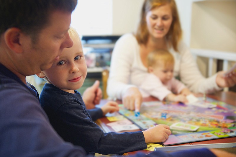 Board games are just one way parents can connect with their children through play. (Tribune News Service)
