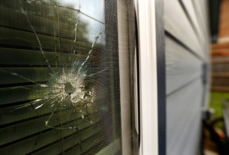 A bullet hole from the police officer's shot is seen in the rear window of Atatiana Jefferson's home on E. Allen Ave in Fort Worth, Texas, Tuesday, Oct. 15, 2019. Jefferson, a black woman, was shot by a white police officer early Saturday, Oct. 12. (Tom Fox/The Dallas Morning News via AP)