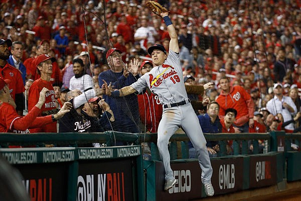 Tommy Edman of the Cardinals catches a ball against the net hit by Anthony Rendon of the Nationals during the fourth inning Tuesday night's Game 4 of the National League Championship Series in Washington.