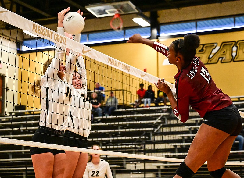 Liberty-Eylau's Daycoria Meadows has a shot blocked by Pleasant Grove's Hallie Lipham and Rachael Leach during a volleyball match Tuesday at Hawk Gym. 