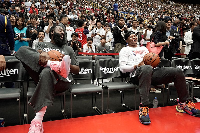 Houston Rockets' James Harden, left, and Russell Westbrook share a light moment during warmups for the team's NBA preseason basketball game against the Toronto Raptors Thursday, Oct. 10, 2019, in Saitama, near Tokyo. (AP Photo/Jae C. Hong)