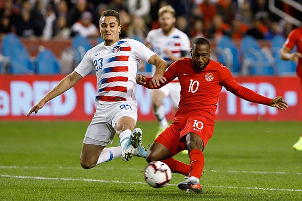 U.S. defender Aaron Long (23) and Canada forward Junior Hoilett (10) vie for the ball Tuesday during the second half of a CONCACAF Nations League match in Toronto.