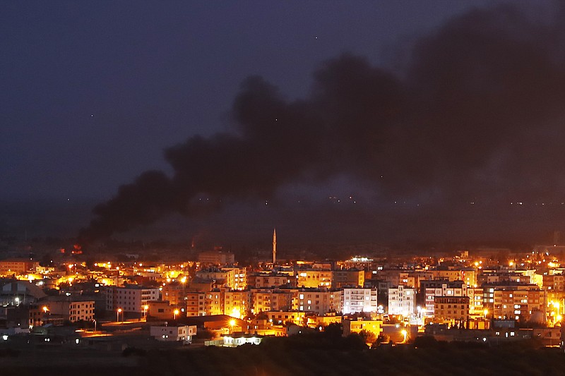 In this photo taken from the Turkish side of the border between Turkey and Syria, in Ceylanpinar, Sanliurfa province, southeastern Turkey, smoke billows from fires in Ras al-Ayn, Syria, caused by bombardment by Turkish forces, Wednesday, Oct. 16, 2019. Turkey's President Recep Tayyip Erdogan called Wednesday on Syrian Kurdish fighters to leave a designated border area in northeast Syria 'as of tonight' for Turkey to stop its military offensive. (AP Photo/Lefteris Pitarakis)