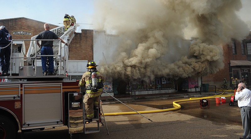 Firefighters battle a fire on Oct. 17, 2019, in downtown Atlanta, Texas.
