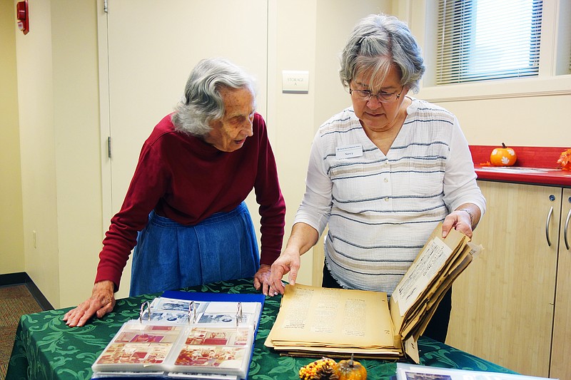 Betty Maddox, left, and niece Nancy Nelson look through scrapbooks documenting the Callaway County Public Library's history. Daniel Boone Regional Library celebrated its 60th anniversary Tuesday.