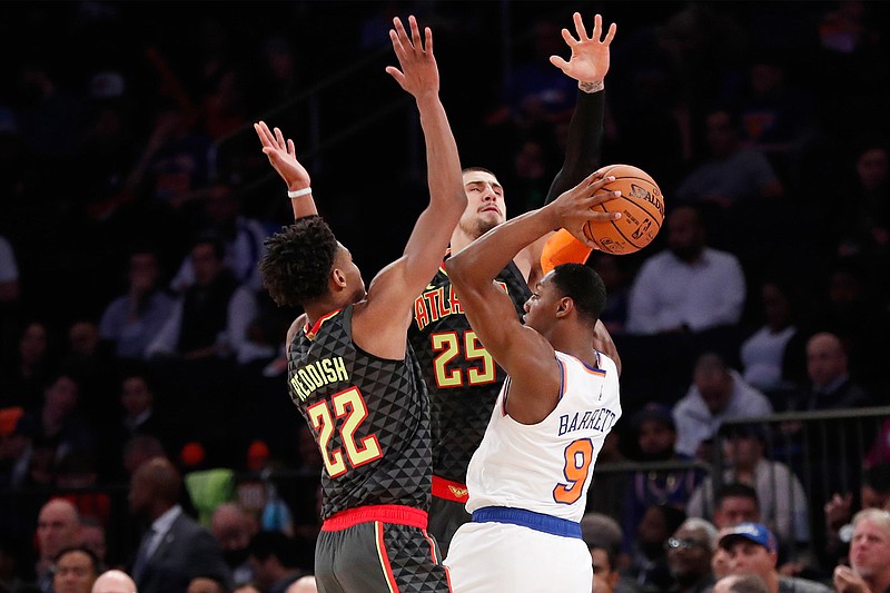 New York Knicks forward RJ Barrett (9) looks to pass with Atlanta Hawks forward Cam Reddish (22) and center Alex Len (25) defending during the first half of a preseason NBA basketball game in New York, Wednesday, Oct. 16, 2019. (AP Photo/Kathy Willens)