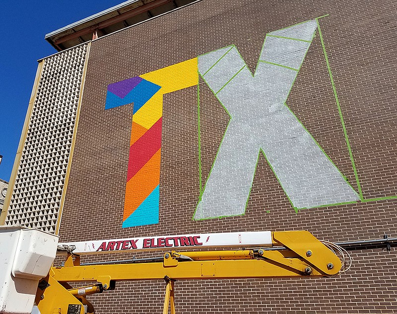 A new mural in progress is shown Oct. 18, 2019, at West Fourth and Main streets in Texarkana, Texas. The city commissioned artist Jes Weiner to paint the mural, which uses a logo first put on a Texarkana Water Utilities water tower.